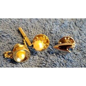 Set of 3 tie and lapel pins.